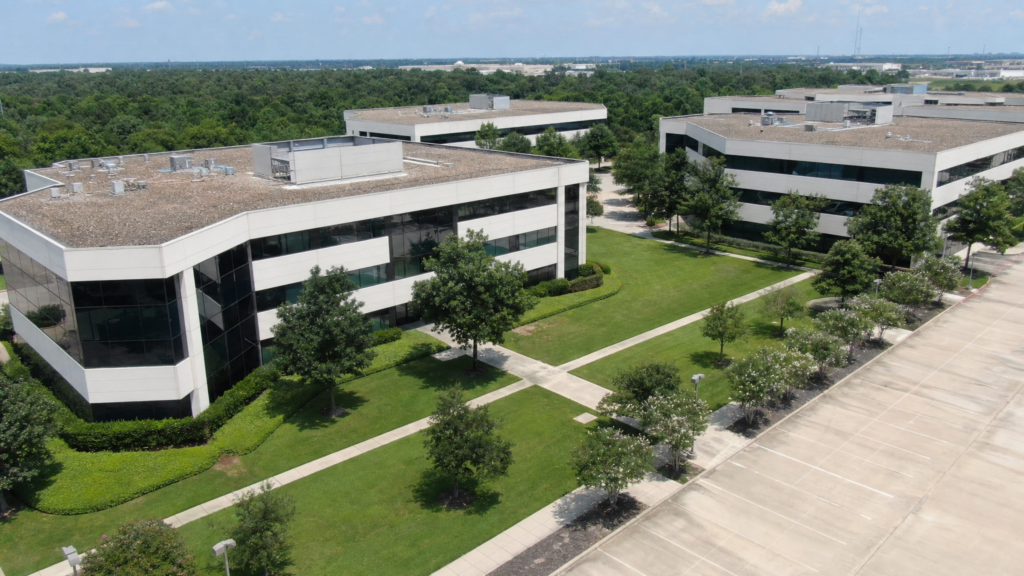 Well-maintained commercial property exterior with manicured lawn and clean parking lot